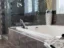 Large-format porcelain tile bathroom with stone-look shower wall and tub surround