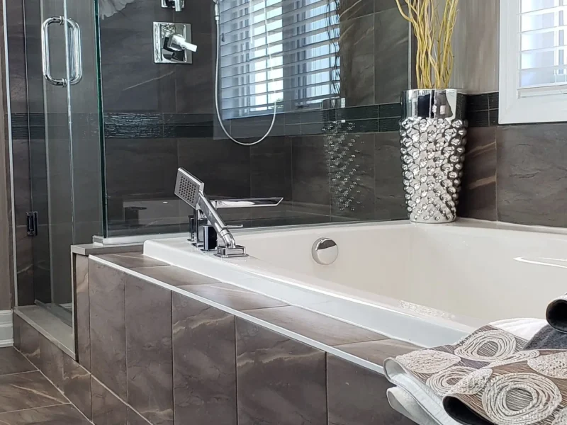 Large-format porcelain tile bathroom with stone-look shower wall and tub surround